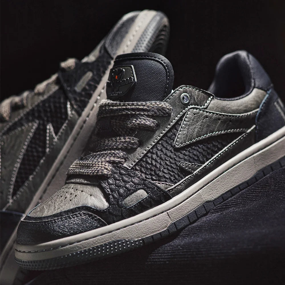 Black and gray sneakers with a reflective label on a black background