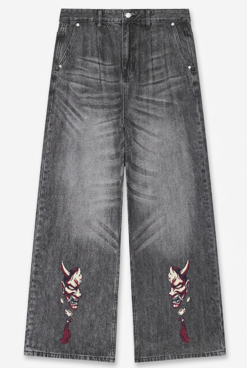 Wide-leg gray denim jeans with embroidered devil mask motifs on the lower left and right legs, shown flat against a light gray background.