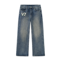 A pair of blue denim jeans with a faded wash, featuring a white and black 'V7' logo patch on the left pocket, displayed against a solid white background.