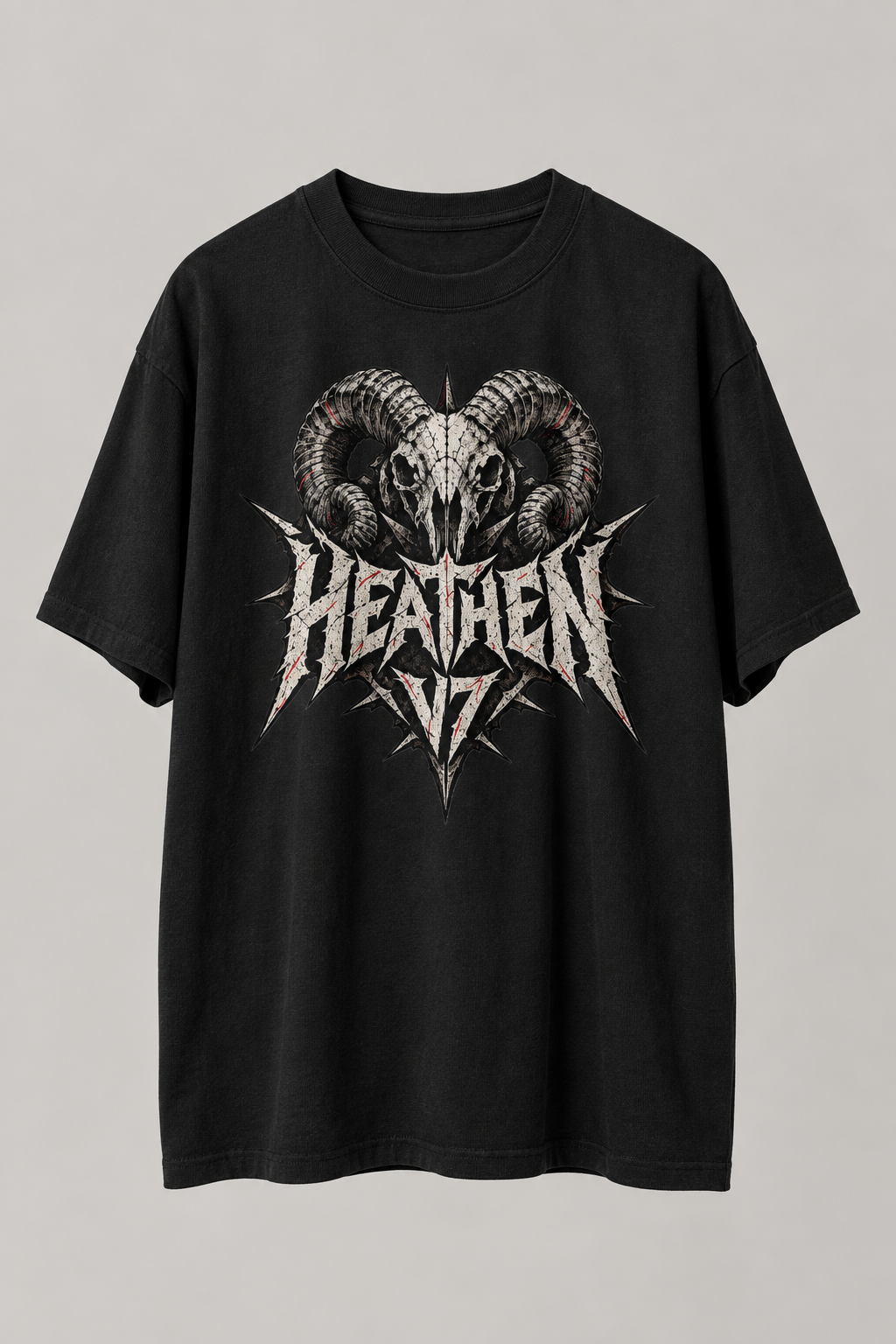 A black short-sleeve graphic t-shirt featuring a ram skull and the word 'HEATHEN' in a distressed metallic silver font, displayed against a neutral gray background.