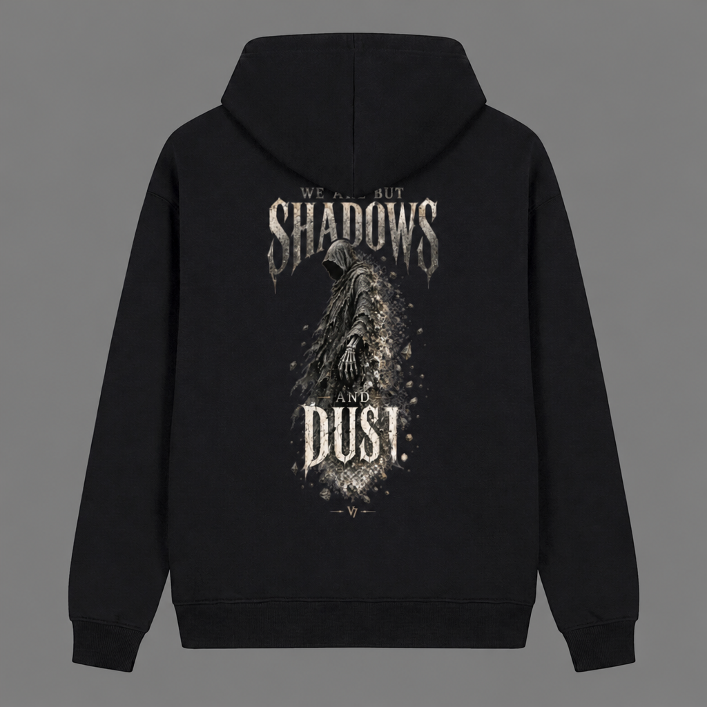 A black pullover hoodie shown from the back, featuring a large distressed graphic print with the words 'SHADOWS' and 'DUST' and a dark hooded figure in the center, on a plain gray background.