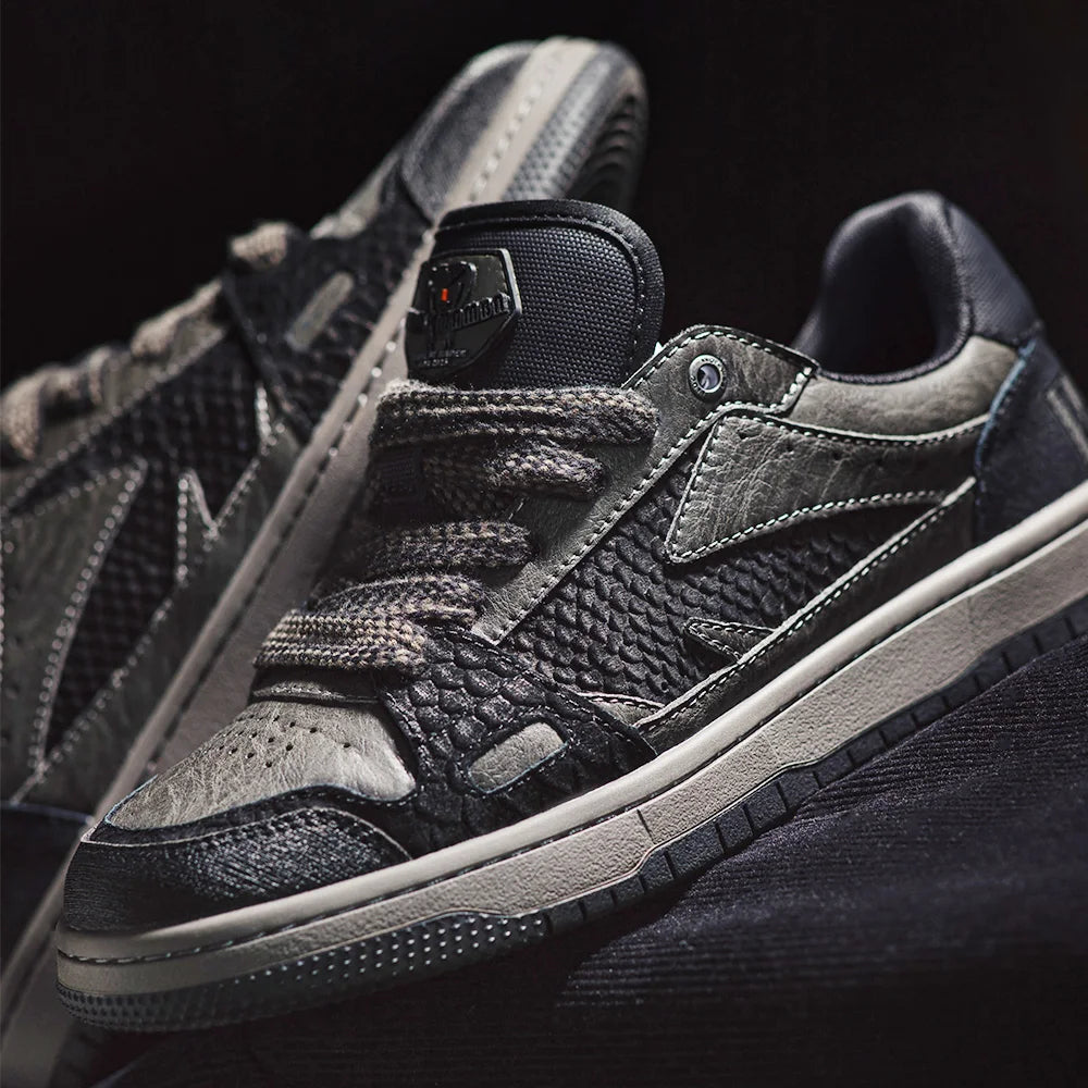 Black and gray sneakers with a reflective label on a black background