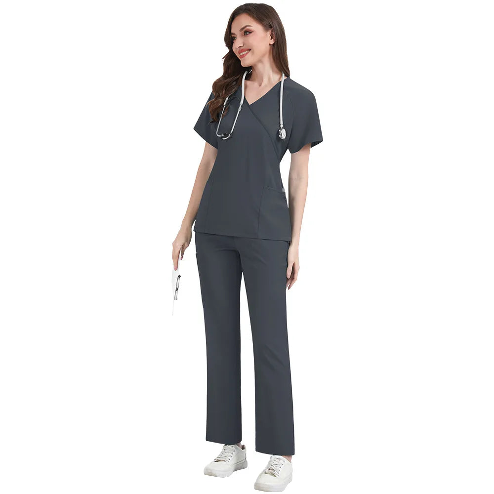 Woman wearing a dark gray medical scrub set on a white background