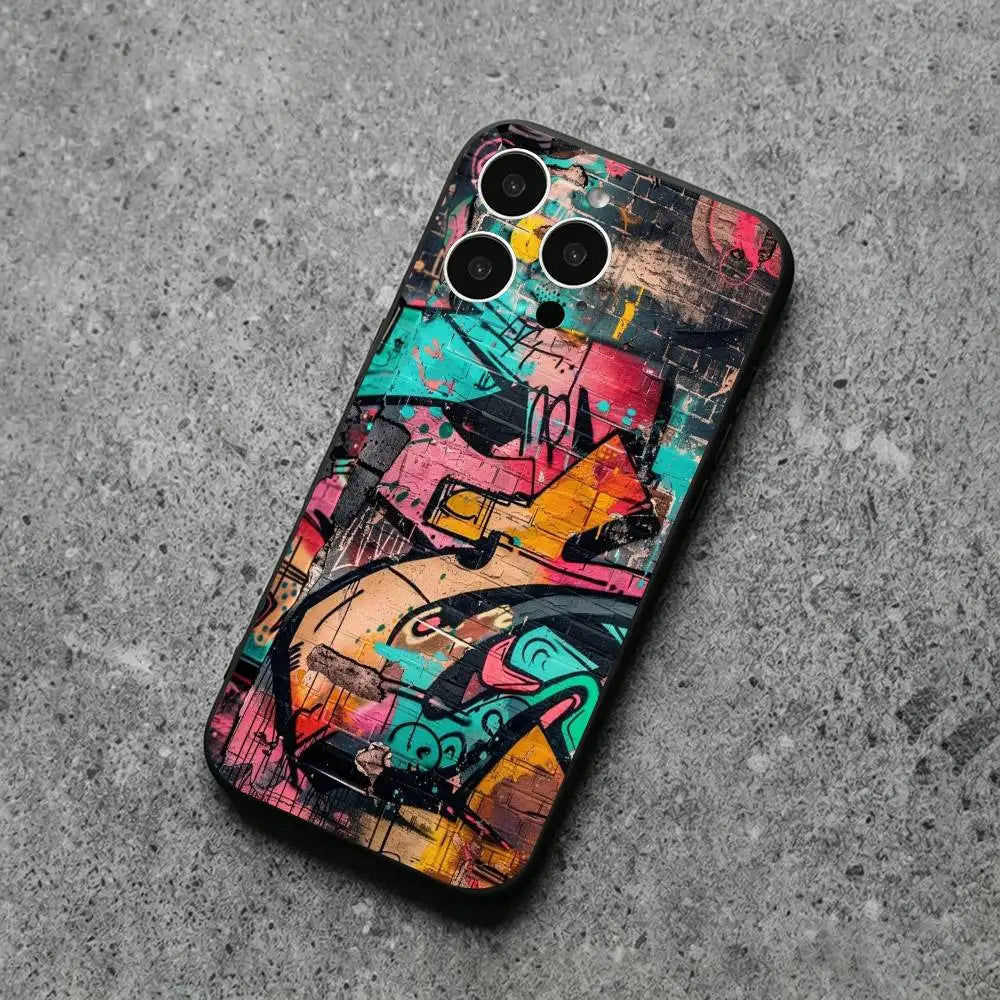 A phone case with a vibrant graffiti art print, shown on a smartphone and placed on a textured gray concrete surface.