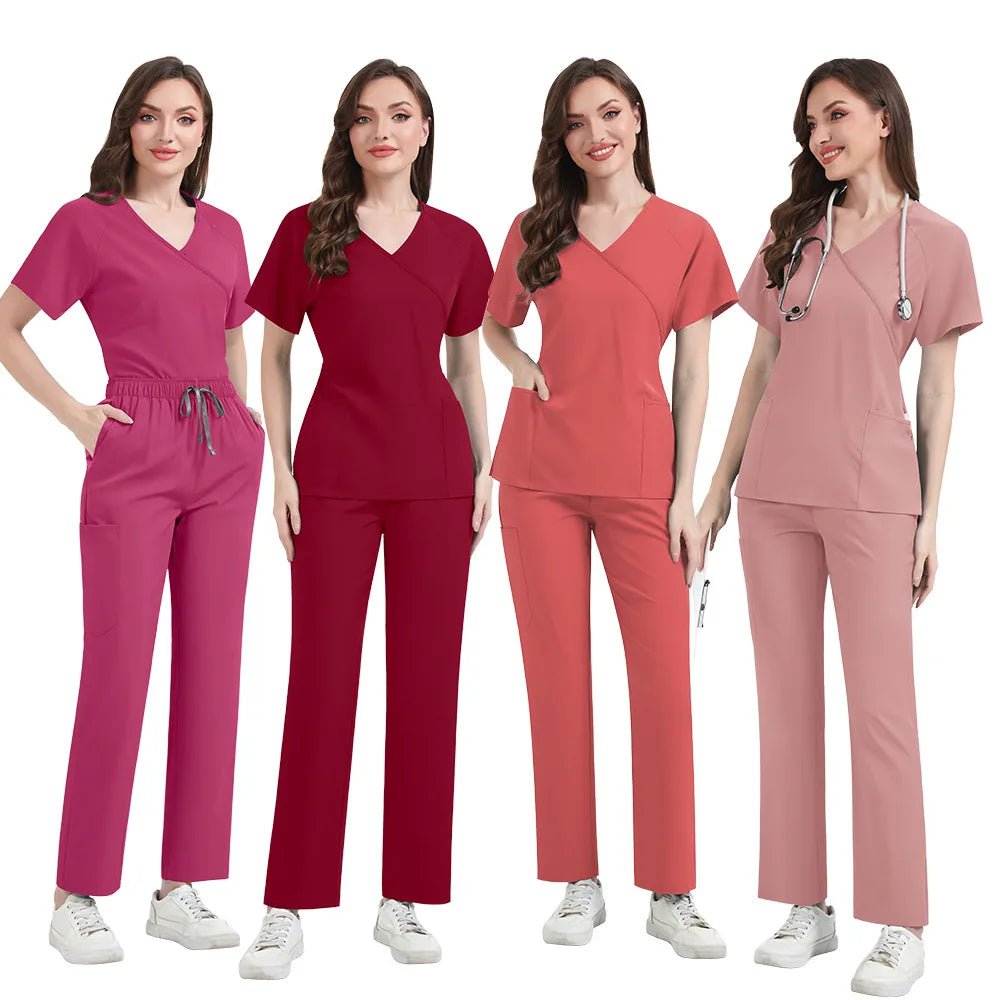 Four women wearing different colored scrub sets on a white background
