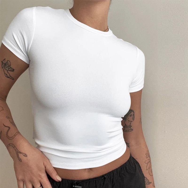 Person wearing a white t-shirt against a neutral background