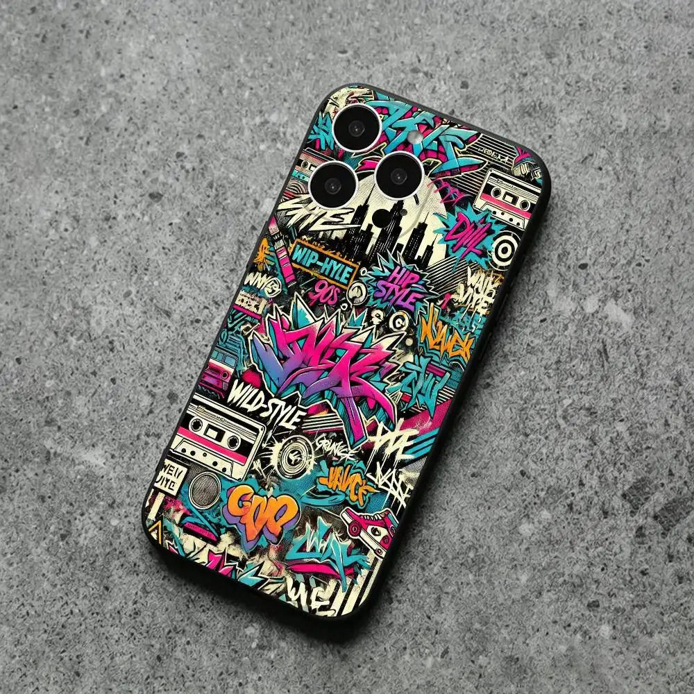 A phone case featuring a vibrant, multicolored graffiti and cassette tape collage design, shown from a top-down perspective on a textured gray concrete surface.