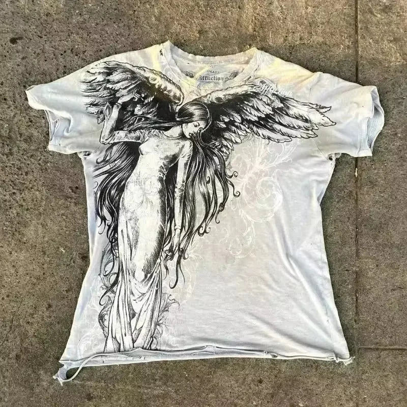 White t-shirt with an angel graphic on a concrete surface