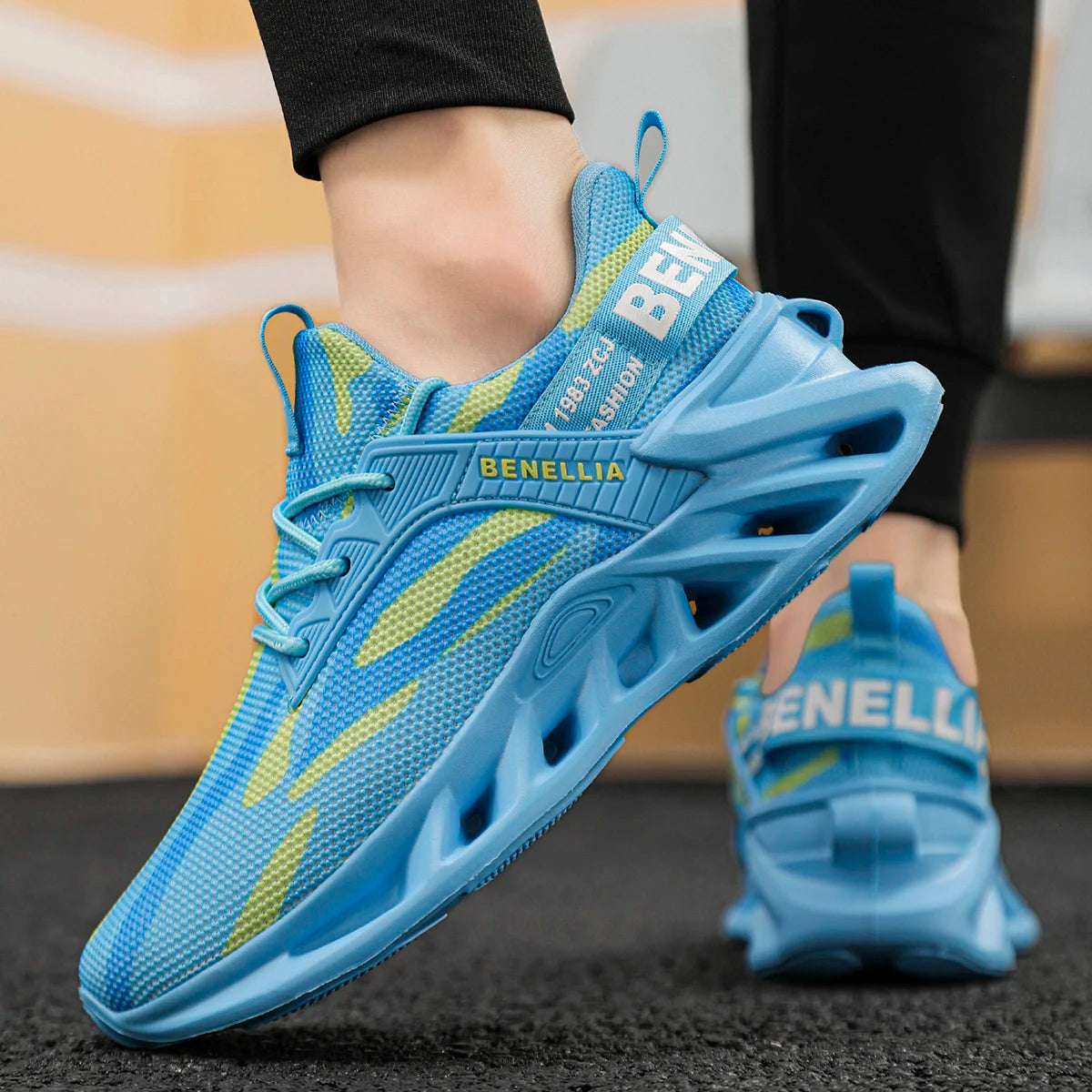 Blue athletic shoes with yellow accents worn by a person, brand 'Benellia' visible.