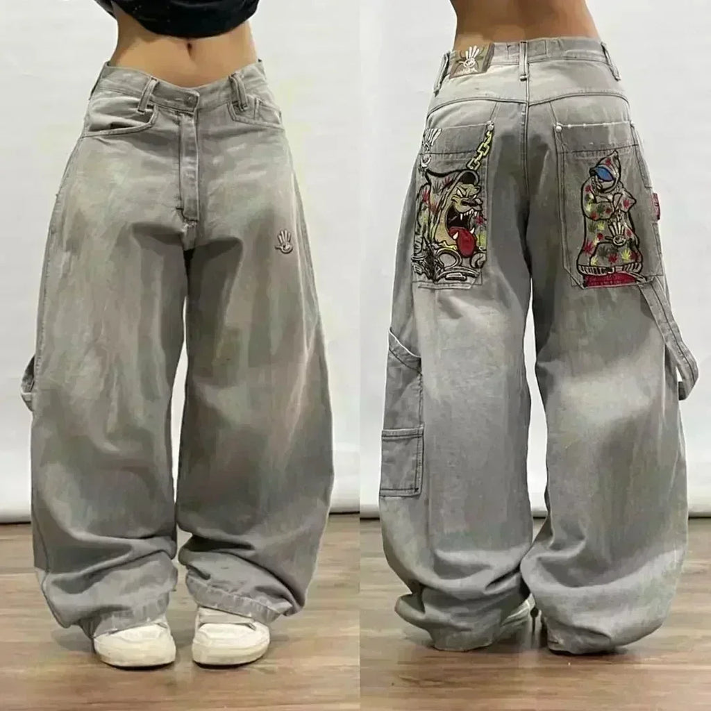 Gray baggy pants with colorful patches on a plain background