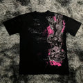 Black t-shirt with a graphic design of a skull and wings on a textured gray surface