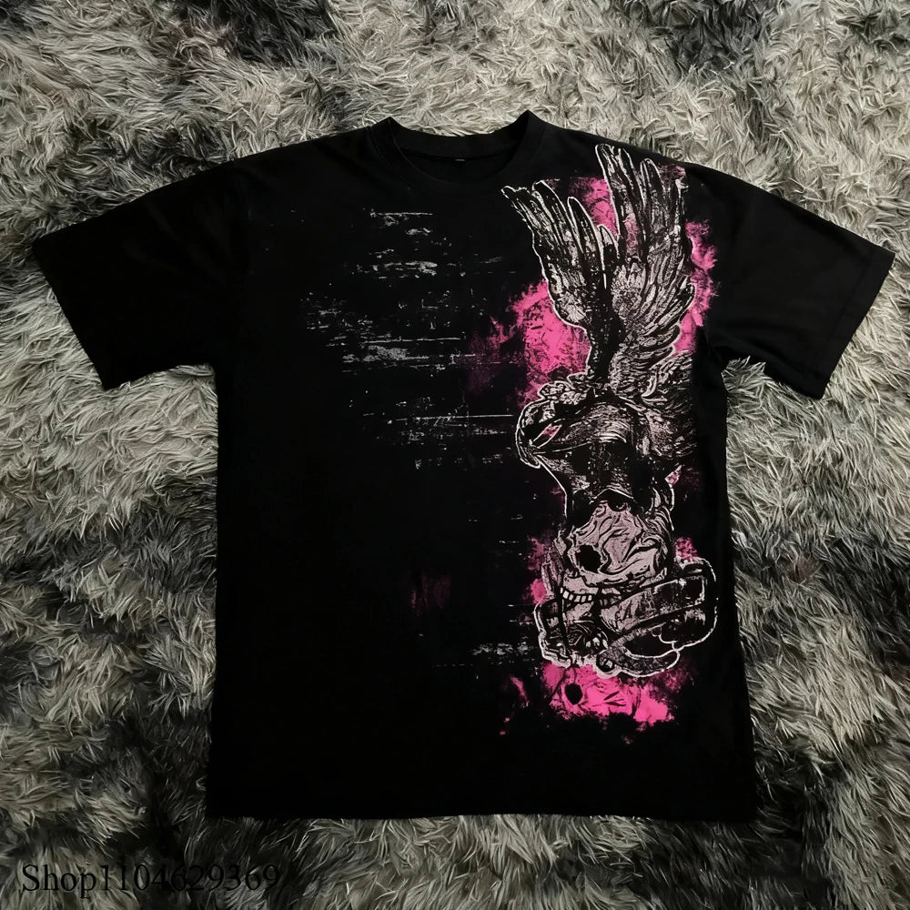 Black t-shirt with a graphic design of a skull and wings on a textured gray surface