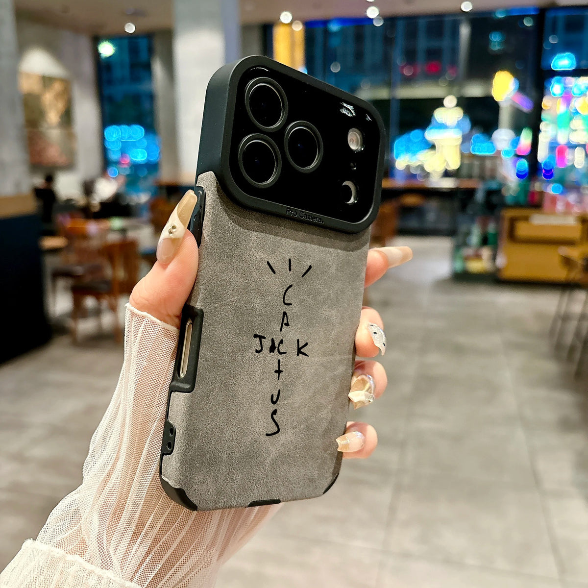 Person holding a phone case with 'LICACJOKUS' branding in an indoor setting.