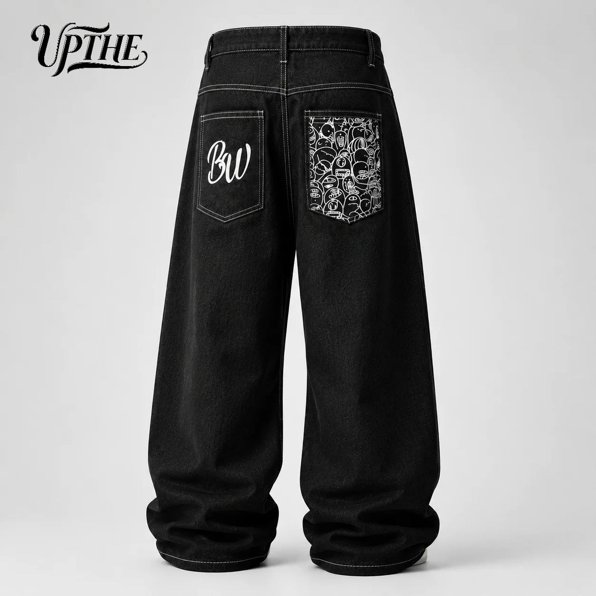 Black wide-leg denim jeans shown from the back, featuring a white embroidered 'BW' on the right pocket and a detailed skull pattern on the left pocket. The brand logo 'UPTHE' is visible in the top left corner.