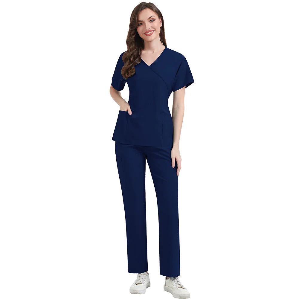 Woman wearing a navy blue medical scrubs set on a white background