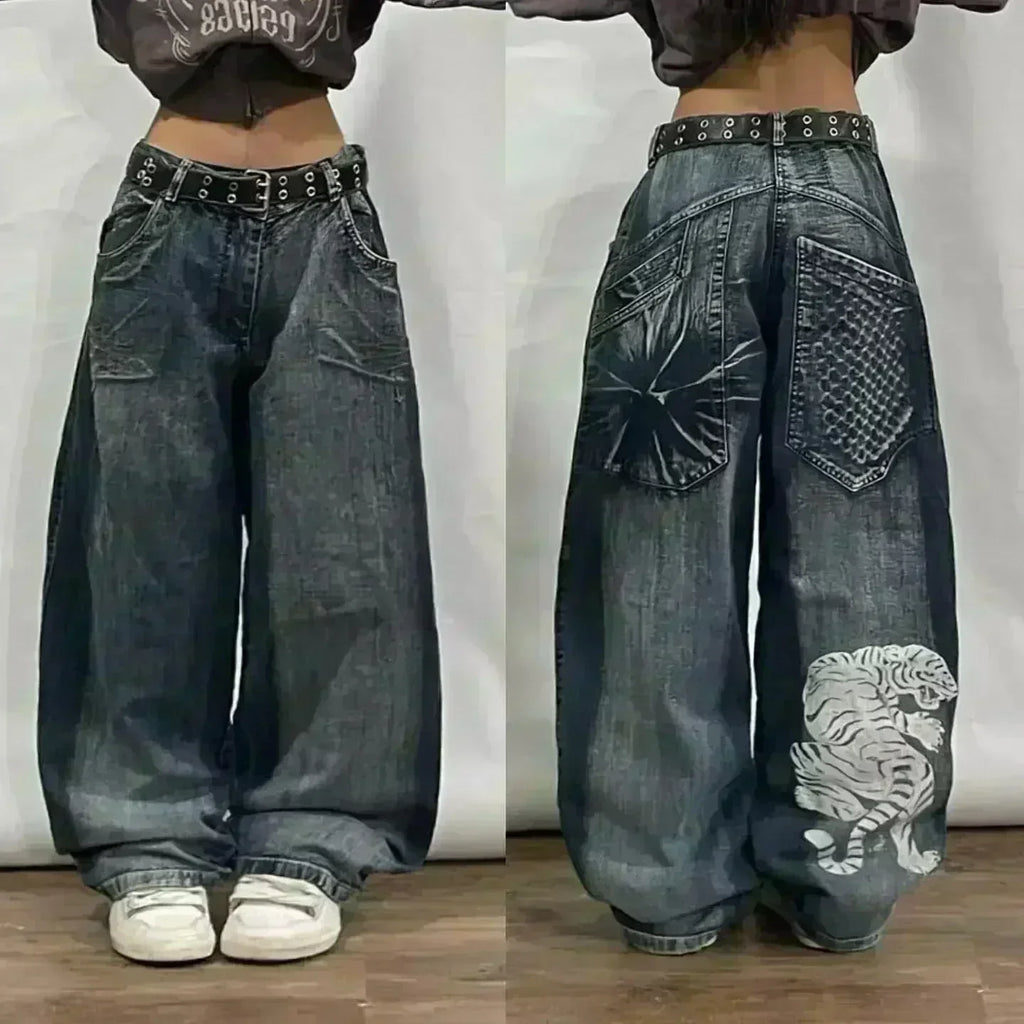 Wide-leg jeans with decorative elements on a plain background
