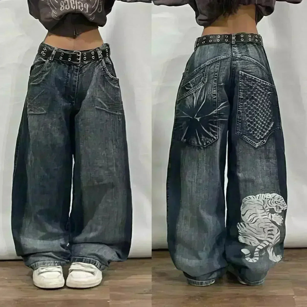 Wide-leg jeans with decorative elements on a plain background