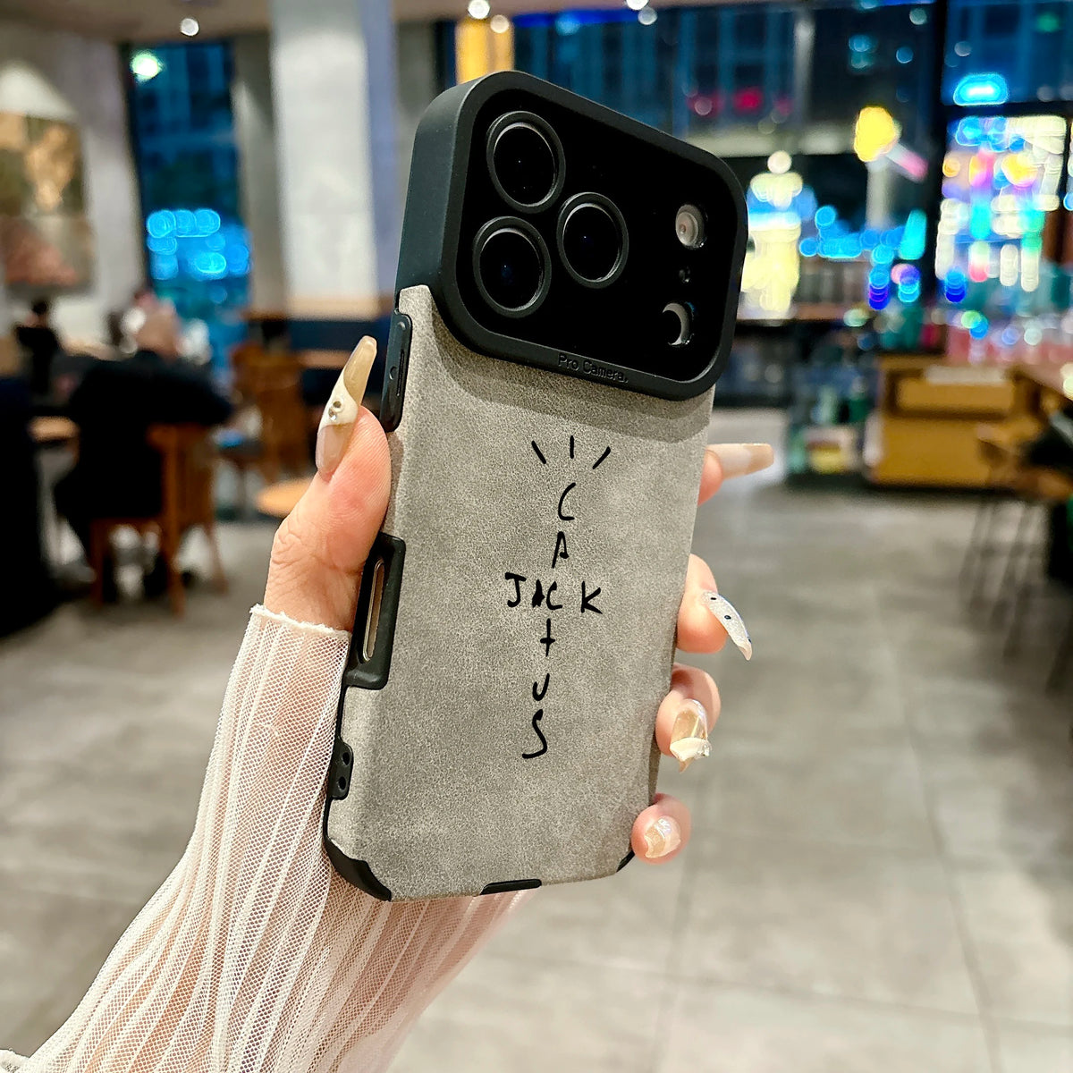 Hand holding a phone case with 'Cakewalk' branding in an indoor setting.