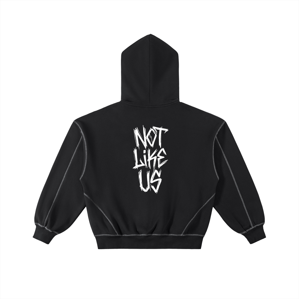 A black cropped hoodie shown from the back, featuring a white distressed graphic that reads 'NOT LIKE US' on the center back. The hoodie has a high hood, ribbed cuffs and hem, and subtle contrast stitching.