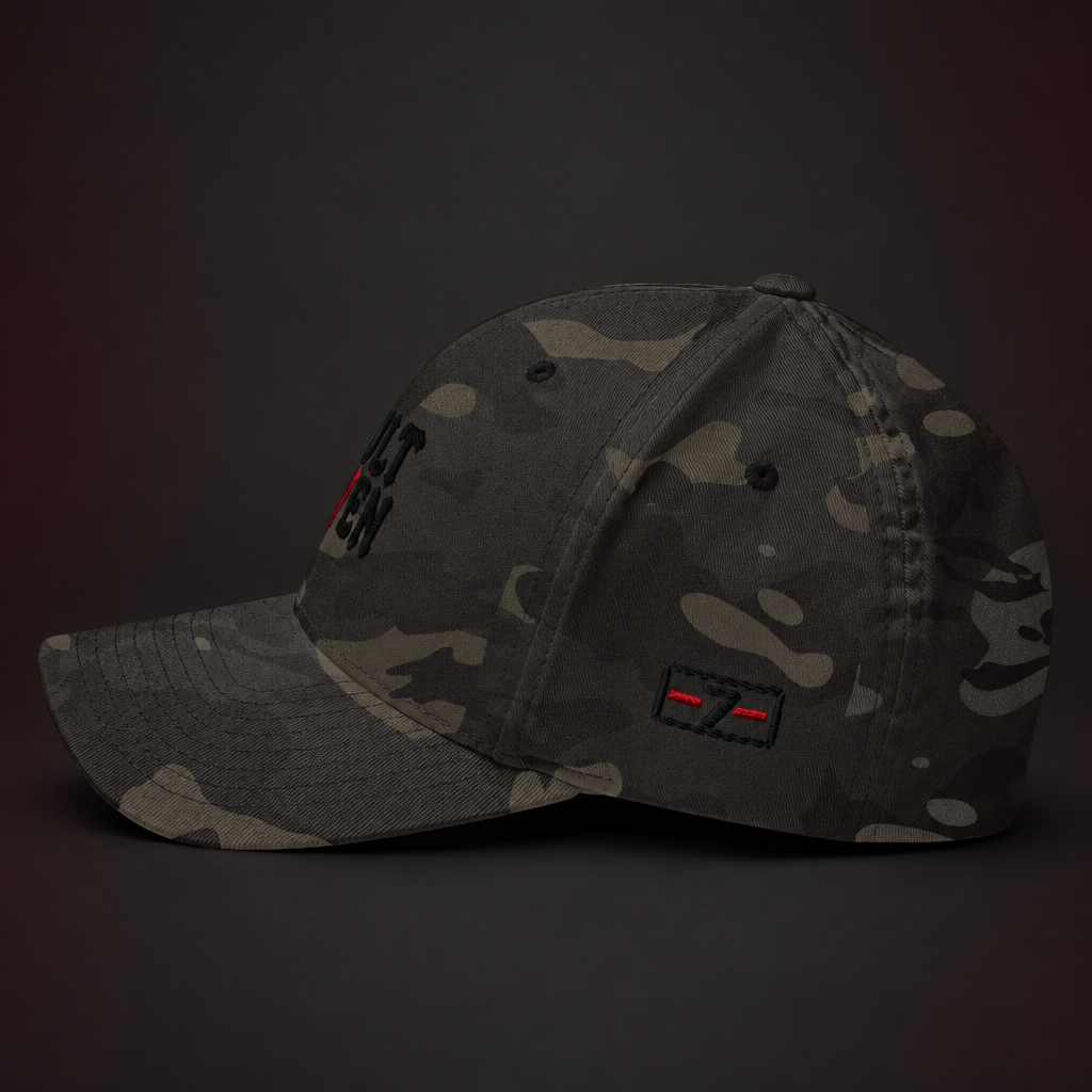 A dark camouflage baseball cap with a curved brim, featuring a black embroidered logo on the front and a small red-and-black patch on the side, photographed against a dark studio background.