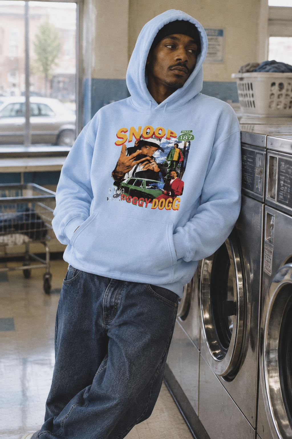 Person wearing the Snoop Dogg graphic hoodie in Color 4 inside a laundromat with natural room light.