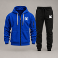Cobalt blue DC zip hoodie with black joggers on a gray studio background