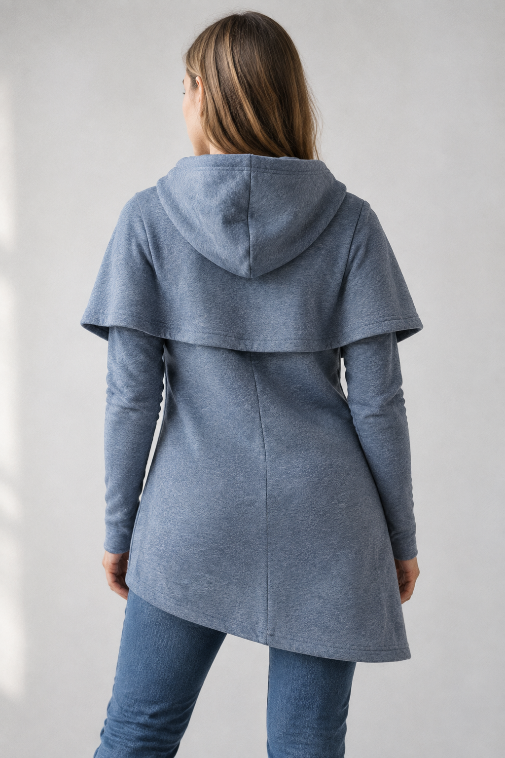 Blue asymmetric hoodie back view showing hood and curved hem